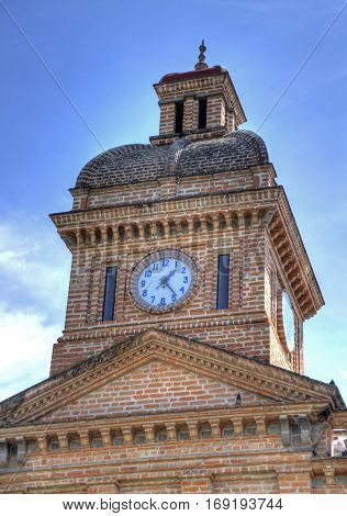 Church tower and clock of an old church in Ibarra, Ecuador, on a sunny morning.