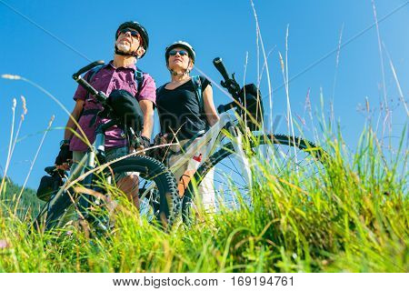 Cycling senior couple enjoying summer at the vilsalpsee in austria