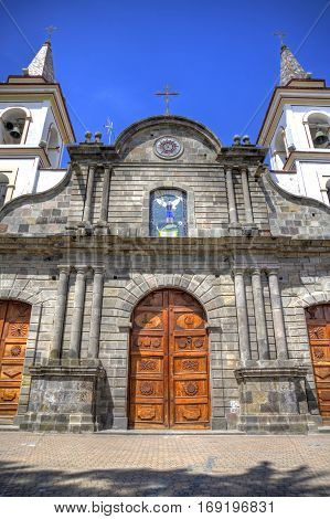Old colonial church facade, on a sunny day in Ibarra, Ecuador.