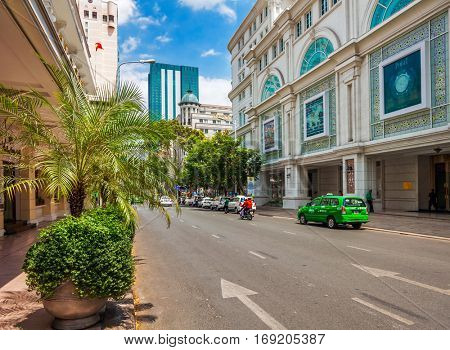 HO CHI MINH, VIETNAM - APRIL 28, 2014: View at one of central streets of Ho Chi Min city with Bitexco Financial Tower on background. Its construction was completed in 2010.