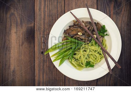 Plate Of Spaghetti Dough With Spinach And Oyster Mushrooms. Italian Cuisine, Italian Recipes. Wooden