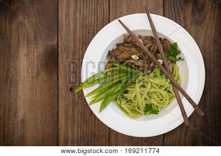 Plate Of Spaghetti Dough With Spinach And Oyster Mushrooms. Italian Cuisine, Italian Recipes. Wooden