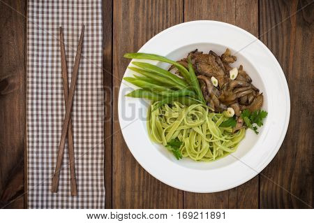 Plate Of Spaghetti Dough With Spinach And Oyster Mushrooms. Italian Cuisine, Italian Recipes. Wooden