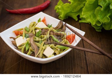 Plate Of Spaghetti Dough With Spinach And Oyster Mushrooms. Italian Cuisine, Italian Recipes. Wooden