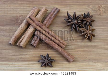 Cinnamon sticks with star anise on brown bamboo board