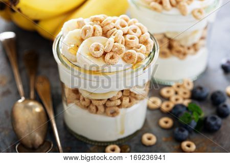 Yogurt parfait with cereal, banana and maple syrup