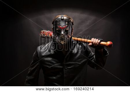 Psycho killer in hockey mask on black background.