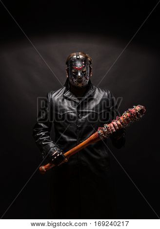 Bloody maniac in mask and black leather coat