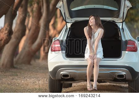 beautiful happy smiling teen girl  on car in the park during morning time holiday
