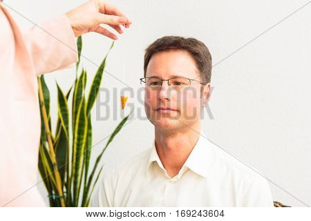 A man is being hypnotized by therapist