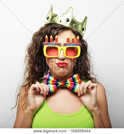 Young woman having fun. Young pretty woman with crown is laughin