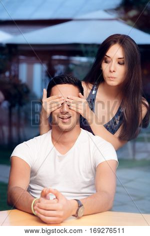 Woman Covering Man's Eyes Taking him by Surprise on a Blind Date