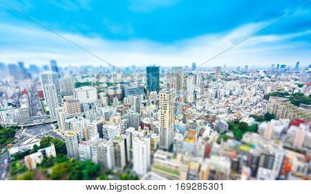 Business and culture concept - panoramic modern city skyline bird eye aerial view from tokyo tower under dramatic sunny and morning blue cloudy sky in Tokyo Japan. Miniature Tilt-shift effect
