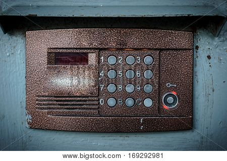Old vintage intercom on apartment building doors