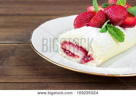 Homemade Sweet roll with Strawberry jam and berries on wooden background. space for text