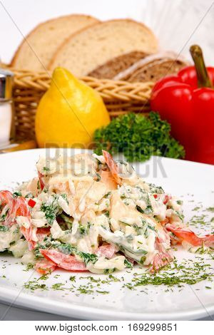 Fish ragout with fresh tomatoes on a white plate with spices
