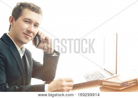 business man working at office with laptop on his desk and calling