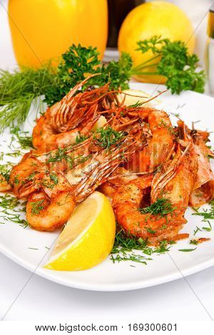 Fragrant shrimp in Chinese style with greens on a white plate