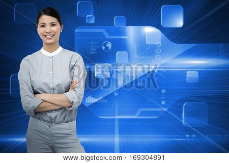 Selfassured businesswoman with folded arms against futuristic technology interface