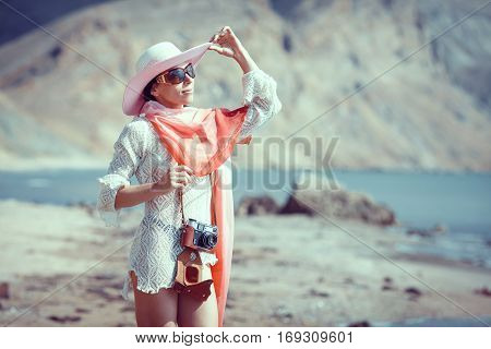 Happy woman enjoying beach relaxing joyful in summer by tropical blue water.