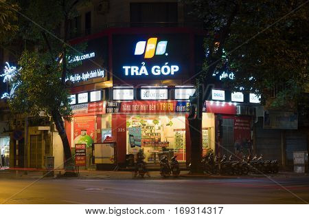 Hanoi, Vietnam - Nov 2, 2014: Front view of a mobile phone store of FPT Telecom in Hanoi capital at night. FPT is one of the biggest technology groups in Vietnam.