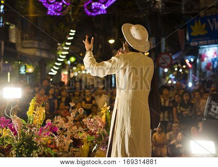 Hanoi, Vietnam - Nov 2, 2014: Male artist performs folk music and song. The show is free for tourist every night on Ma May st in old quarter of Hanoi.
