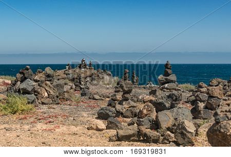 beautiful view of Lanzarote cliff with stone figures and bluea sea with horizon on the background