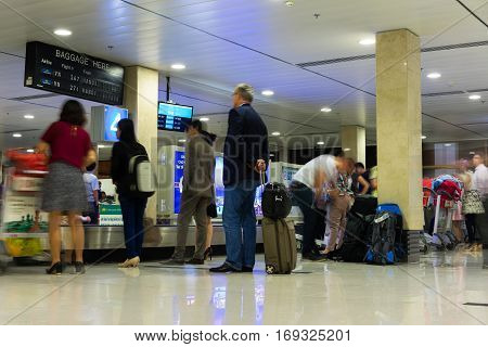 Hanoi, Vietnam - Nov 27, 2014: Passengers waiting for luggage at baggage returning belt in Noi Bai airport