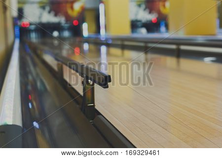 Bowling alley background. Lane with bumper rails closeup. Leisure activity club