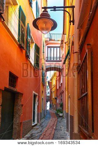 Picturesque colorful narrow curve small street with streetlight in Manarola fishing village in Five lands, Cinque Terre National Park, Liguria, Italy.