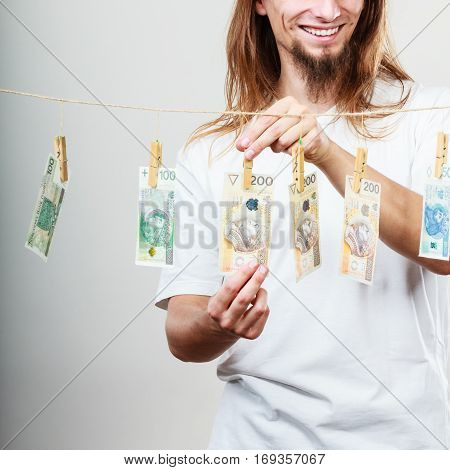 Riches and fortune. Young happy man with a lot of money on grey background. Winning the lottery concept.
