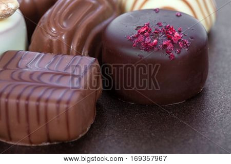 Gourmet bonbons, aka bon-bons or truffles made of milk chocolate. Closeup macro.
