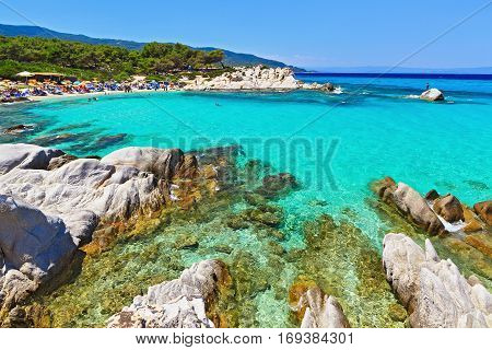 Wonderful sea lagoon with clear turquoise water mountains in the background on a bright sunny day looks like a paradise