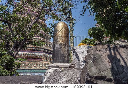 Thailand Bangkok. Temple of the Reclining Buddha (Wat Pho). Black phallus (lingam) - men touching it ask for prosperity and good luck and women - the possibility of the child's conception.