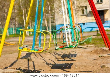 Empty Playground and swings in colorful park Russia.