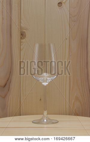 transparent glass standing on a wooden stand with a wooden background