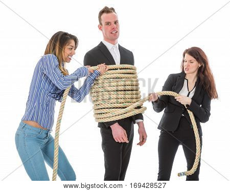 Two angry woman tying a business man with rope isolated on a white background