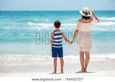 Back view of mother and son at Thai beach, Koh Phangan island, Thailand, Asia