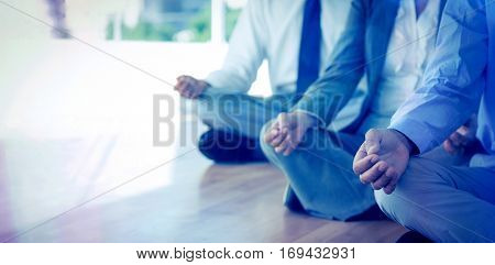 Close up view of business people doing yoga in office