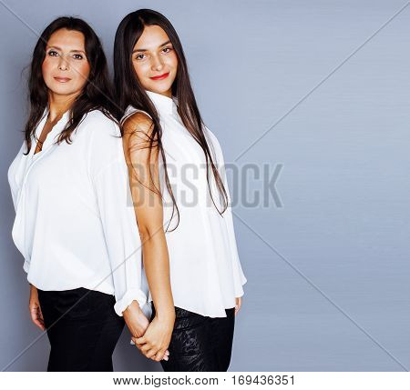 cute pretty teen daughter with mature mother hugging, fashion style brunette, lifestyle people concept close up