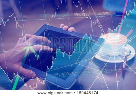 Stocks and shares against close-up of digital tablet and coffee on table Close-up of digital tablet and coffee on table in the coffee shop