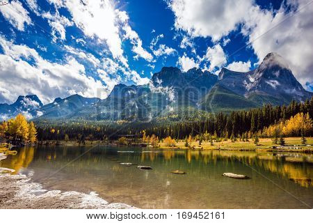 The famous Three Sisters mountains in the Canadian Rockies  of Canada. Auroral sunny day in Canmore. Concept of hiking