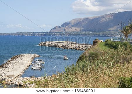 Coastline view from Via Marina of a boat marina next to the beach