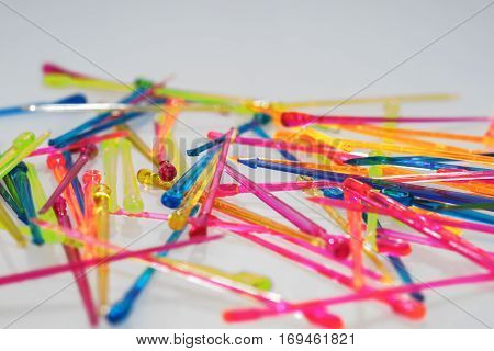 Variety of cocktail sticks on white background. Chaotic background