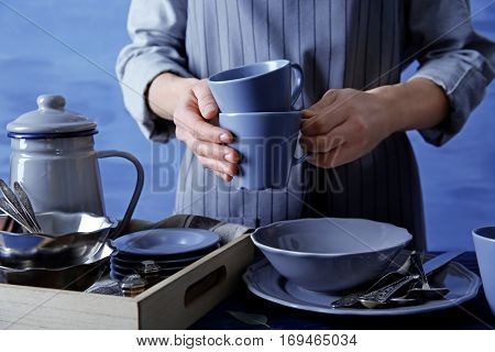 Closeup of female hands holding cups