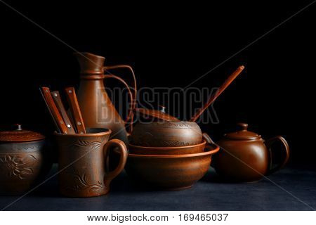 Brown dishware on table and black background