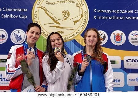 ST. PETERSBURG, RUSSIA - DECEMBER 17, 2016: Winners of X Salnikov Cup in women 200 m breaststroke swimming Maria Temnikova (center), Sofia Andreeva (left) and Maya Mitrofanova, all from Russia