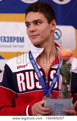 ST. PETERSBURG, RUSSIA - DECEMBER 17, 2016: Bronze medalist in 50 m freestyle swimming Evgeny Rylov in medal ceremony of X Vladimir Salnikov Cup. Athletes from 6 countries participated in the cup