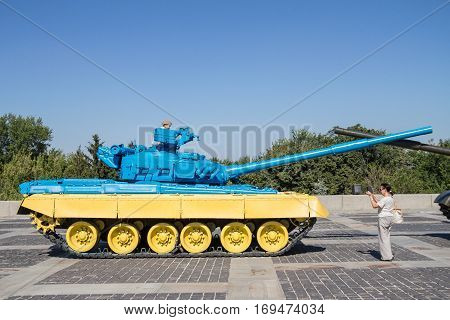 KIEV UKRAINE - AUGUST 9 2015: Russian T55 tank captured in Eastern Ukraine by the Ukrainian army painted with the Ukrainian colors used as a trophy
