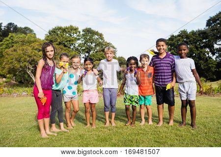 Kids posing together during a sunny day at camera at park